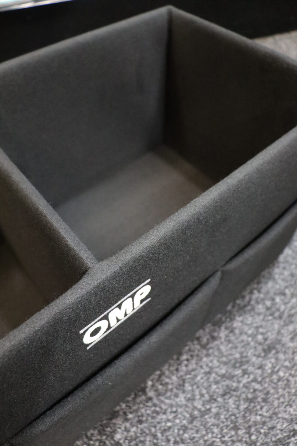 Close up of the padded velour interior of the OMP helmet box with the OMP logo on the side