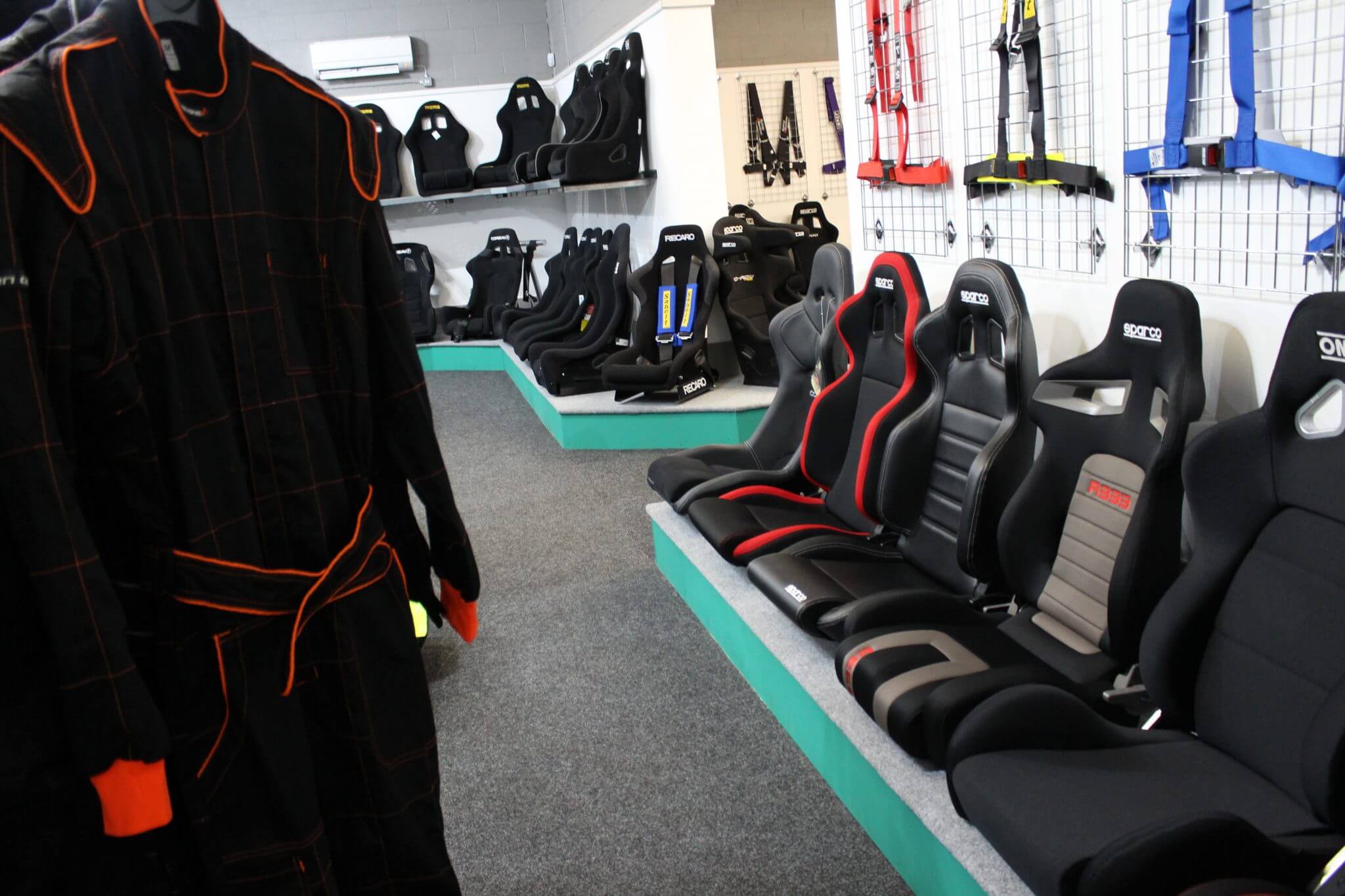 Race suit display wall at GSM Performance