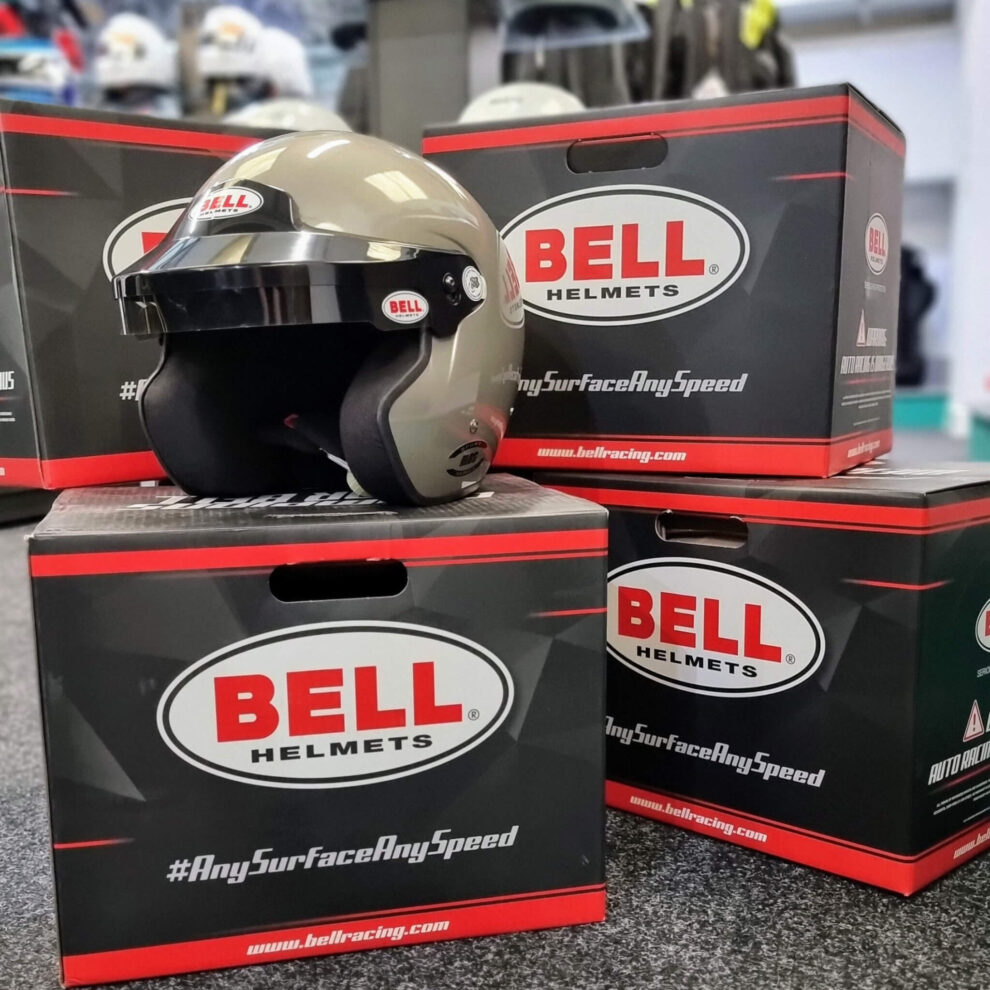 A titanium silver Bell Mag open face helmet sitting on Bell helmet boxes in the GSM Performance showroom
