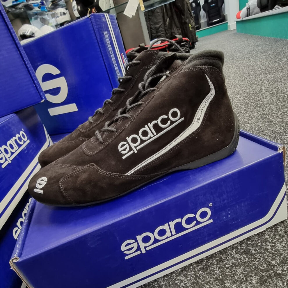 A black suede Sparco Slalom race boot on a blue Sparco box in the GSM Performance showroom