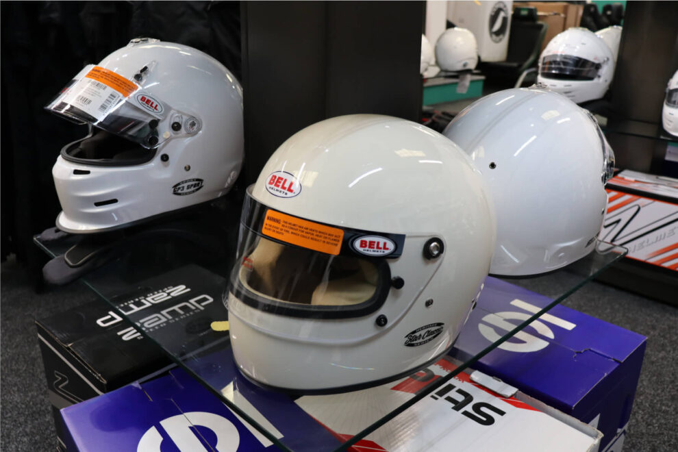 Bell Star Classic helmet on a display box beside modern white full face helmets