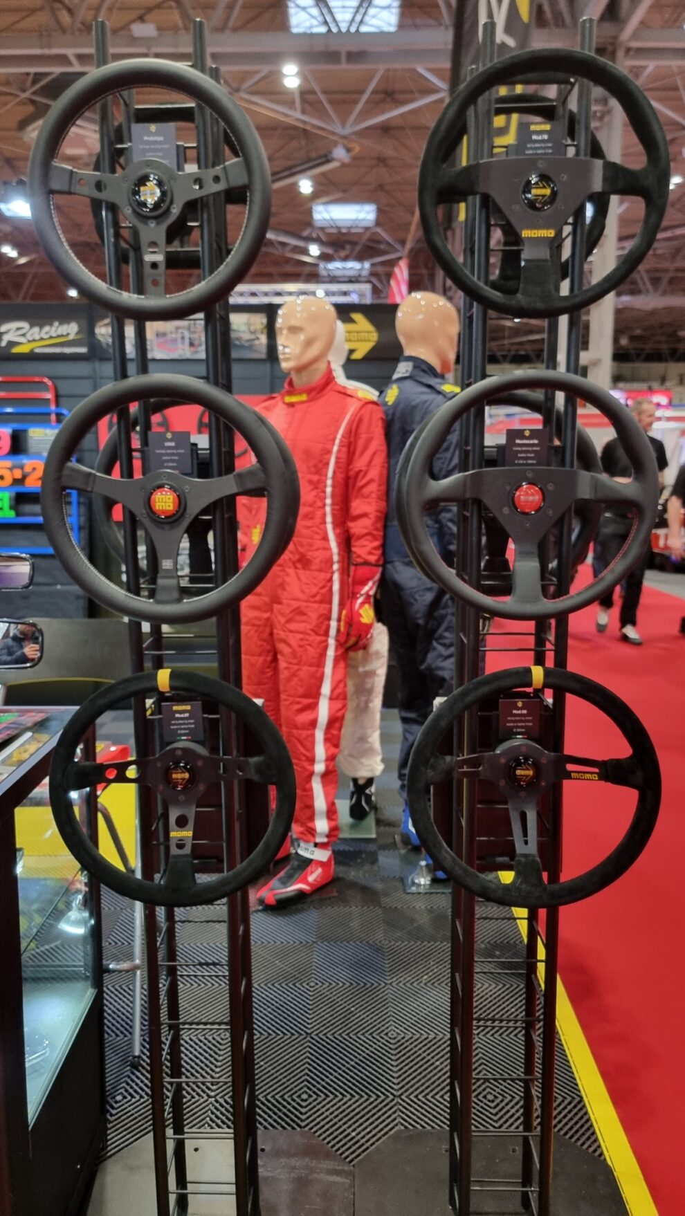 MOMO steering wheels mounted on black display towers at Autosport International 2023