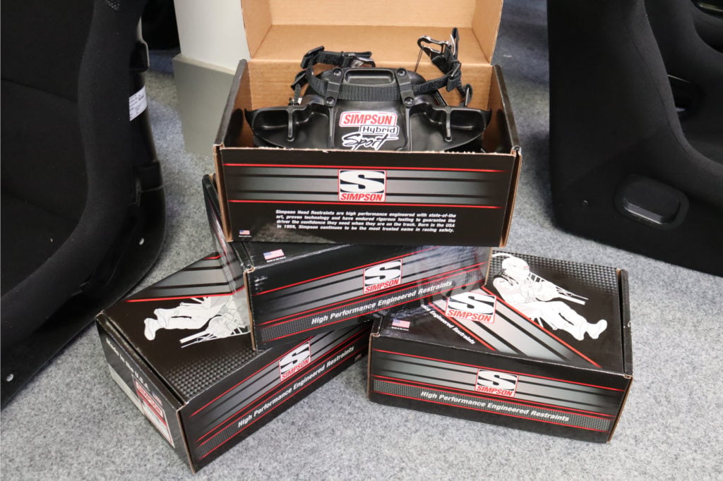 Simpson Hybrid Sport head and neck restraint in its open box on the GSM Performance showroom floor