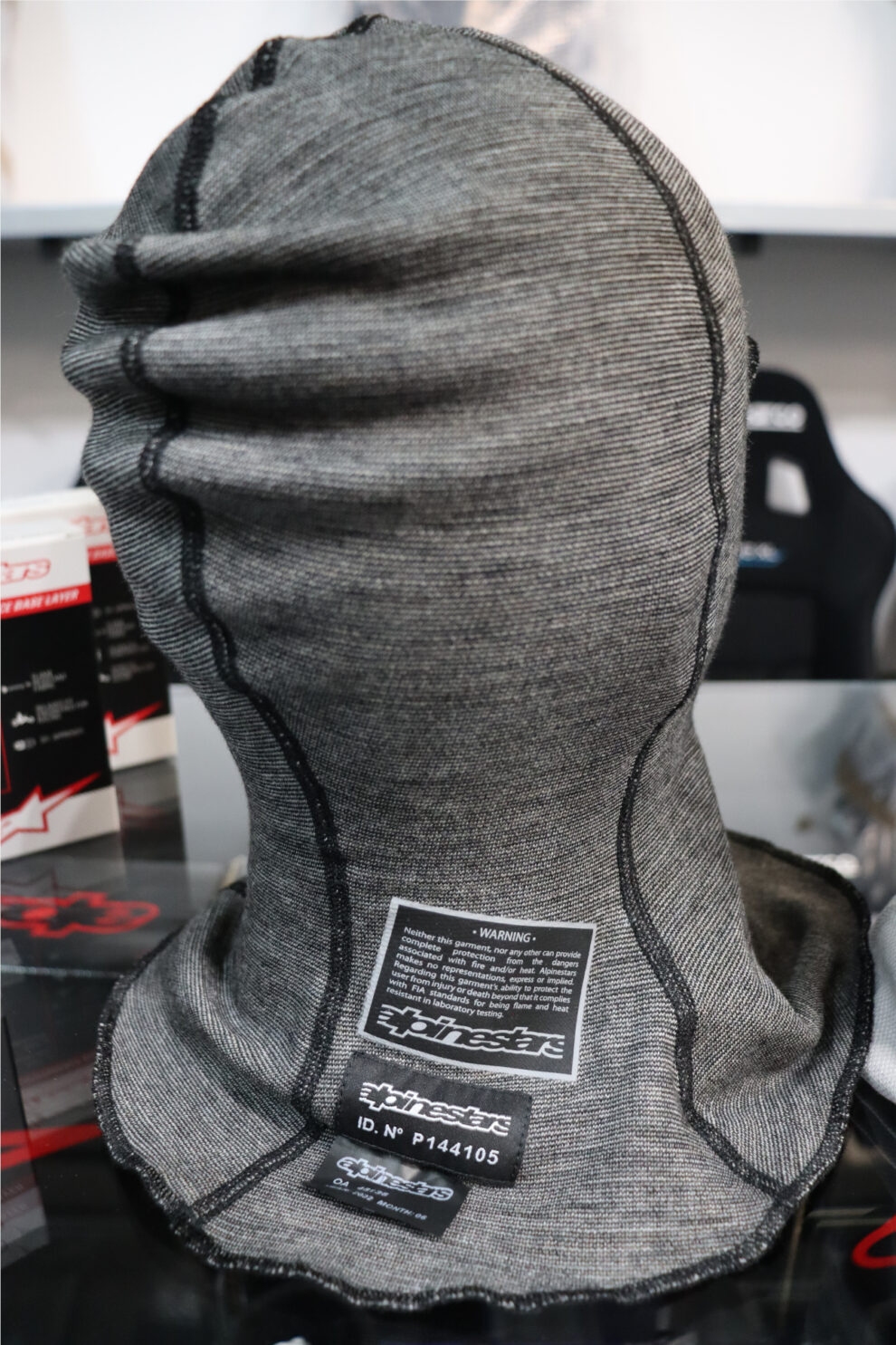The back of an anthracite Alpinestars Race V3 balaclava showing its seams and label