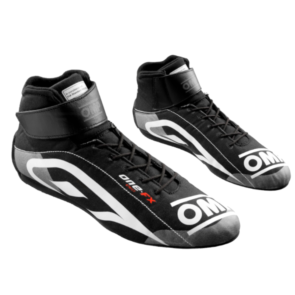 A pair of black OMP One Evo FX race boots with white OMP logos and a velcro ankle strap