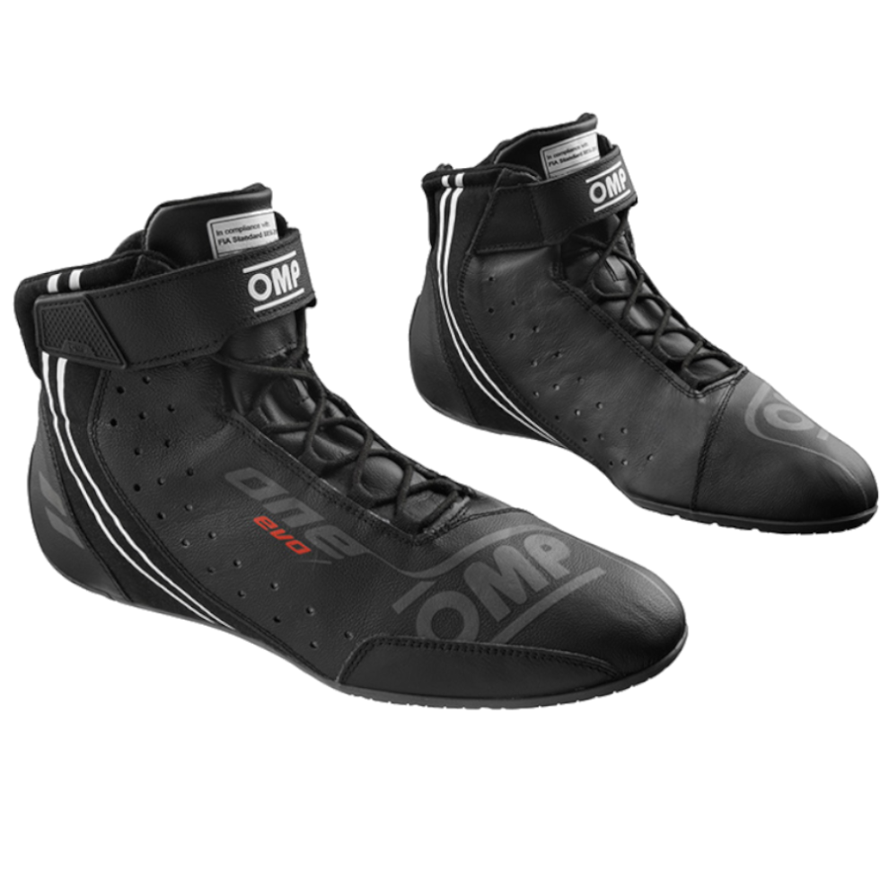 A pair of black OMP One Evo X race boots with a Velcro ankle strap, cord laces and perforated leather upper, on a white background