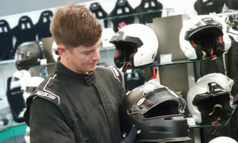 A customer being fitted for a race suit in the GSM Performance showroom