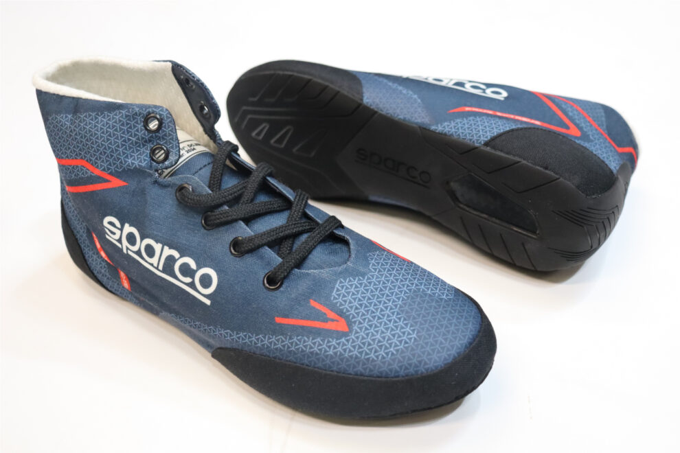 Two navy Sparco Prime Extreme race boots, one showing the black rubber sole with its rear spoiler
