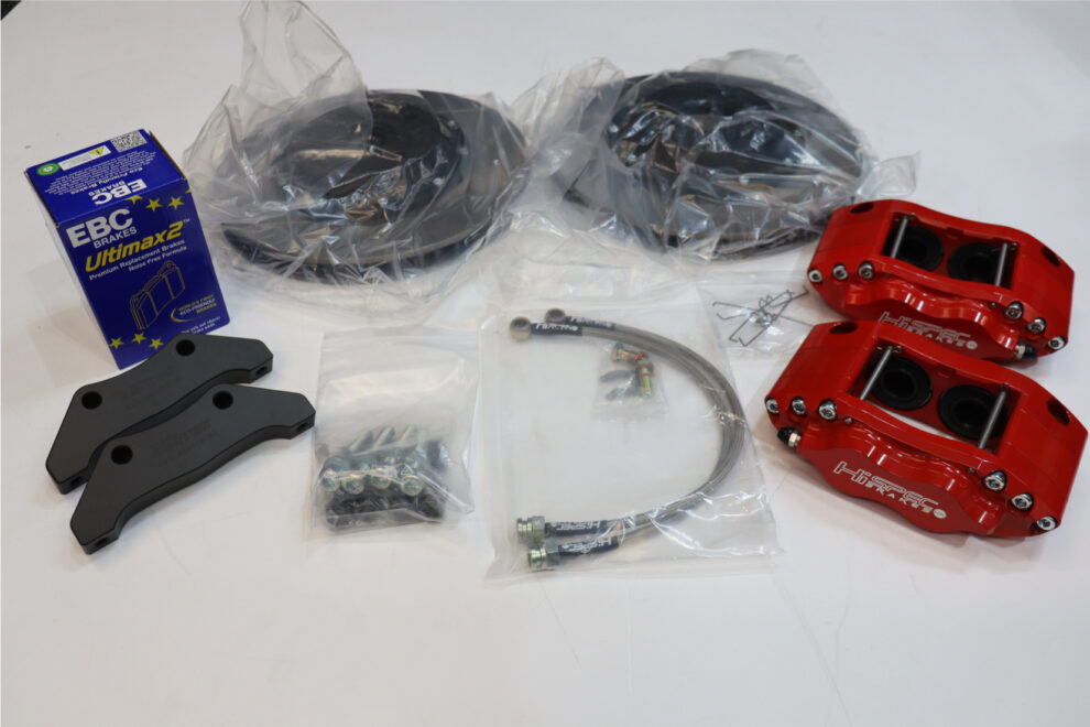 The Hi Spec Nova kit still in its bags: two discs, two red calipers, black brackets, a box of EBC pads, bolts and braided hoses