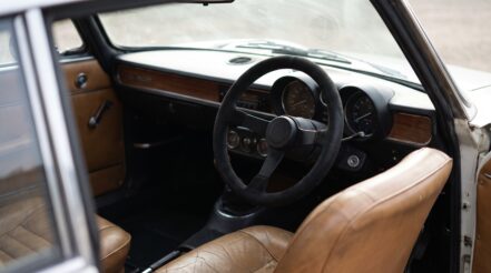 1970s Alfa Romeo GTV coupe fitted with an aftermarket motorsport steering wheel