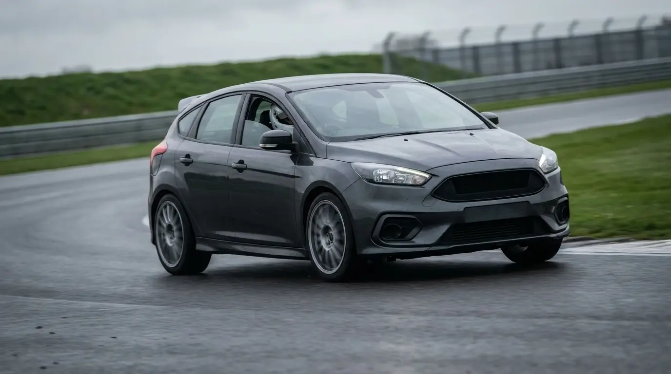 Performance hatchback on track showing suspension travel