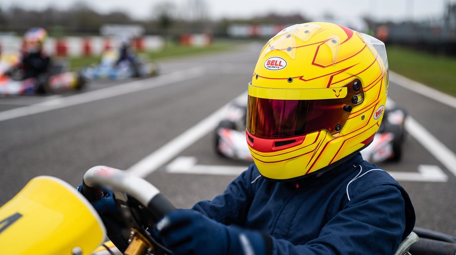 Junior driver wearing a Bell KC7-CMR Lewis Hamilton 2026 kart helmet on the grid - GSM Performance