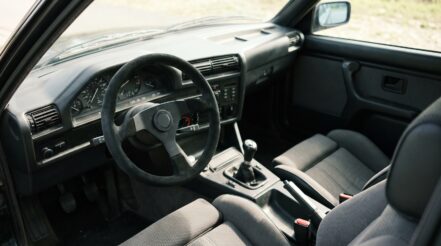 1980s BMW E30 3 Series fitted with an aftermarket motorsport steering wheel