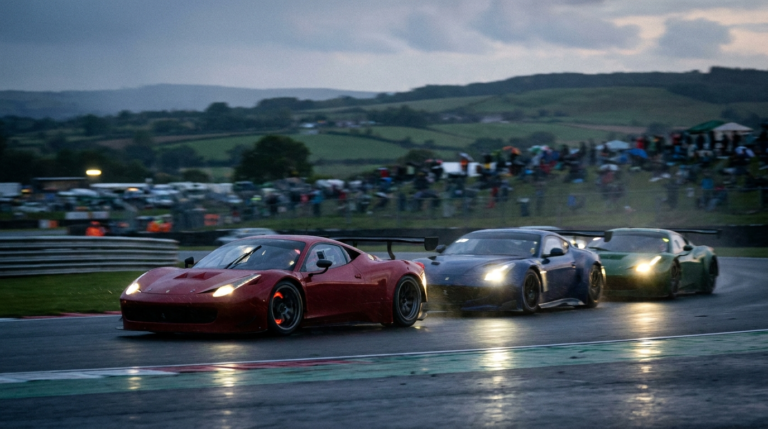GT cars racing at dusk with headlights on