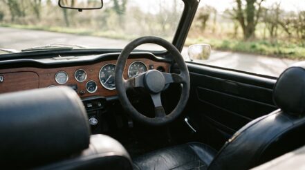 1970s Triumph TR6 roadster fitted with an aftermarket motorsport steering wheel