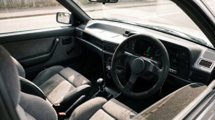 1980s Vauxhall Astra GTE or Opel Kadett hatchback fitted with an aftermarket motorsport steering wheel