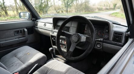 1980s Volvo 240 saloon fitted with an aftermarket motorsport steering wheel