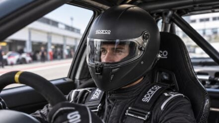 Motorsport driver clearly visible through the visor of a black Sparco Stealth RF full-face helmet