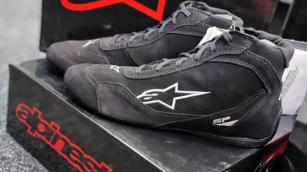 A pair of black Alpinestars SP race boots on their box in the GSM Performance showroom