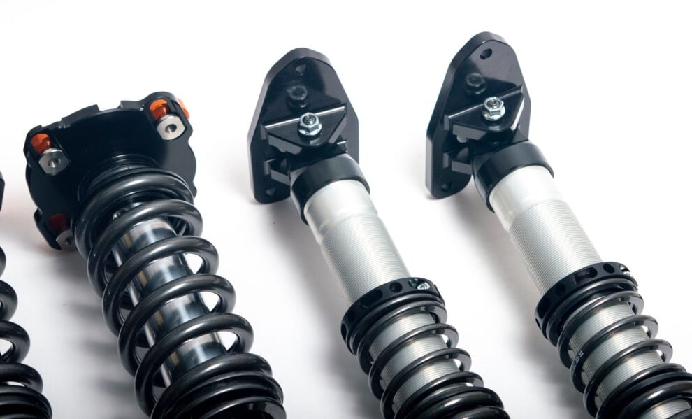 AST 5100 Clubracing coilovers showing the front camber top mount and solid rear top mounts