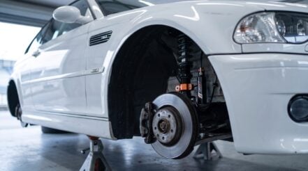 An AST 5300 front strut fitted in the wheel arch of a BMW E46 M3 on axle stands