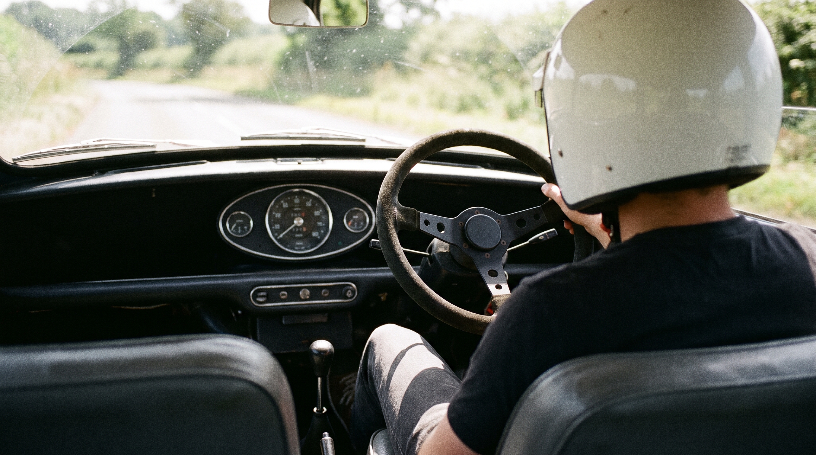 classic 1960s British Mini fitted with an aftermarket motorsport steering wheel
