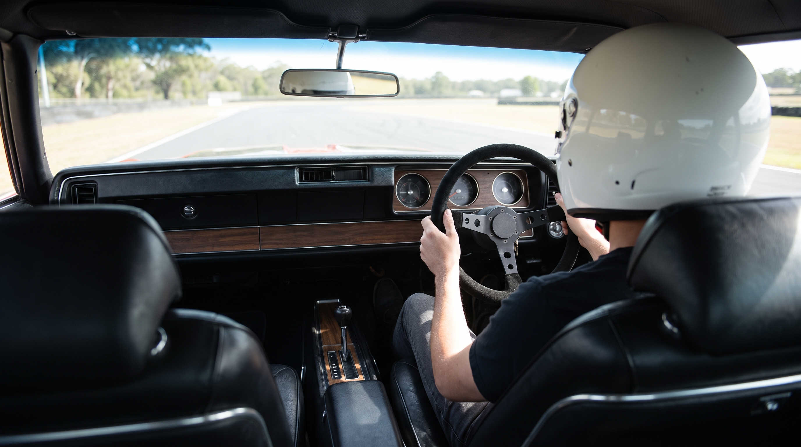 1970s Pontiac Firebird or Oldsmobile Cutlass coupe fitted with an aftermarket motorsport steering wheel