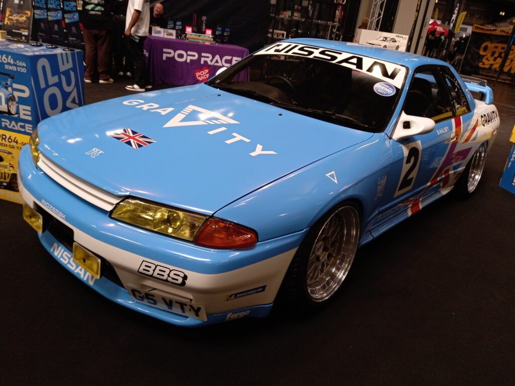 The Gravity Show Nissan Skyline R32 GT-R show car in light blue and white with a Union flag and number 2, on the Pop Race stand