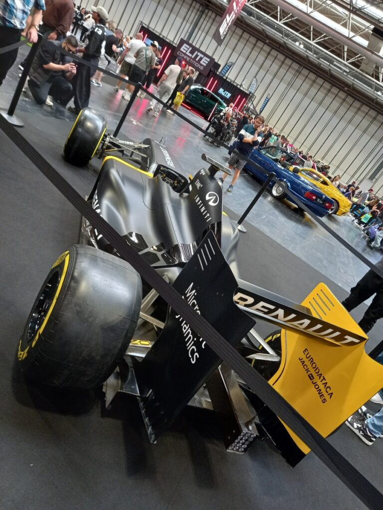 Renault Formula One show car in black and yellow, rear three quarter view with the rear wing and Pirelli tyres, Gravity Show 2026