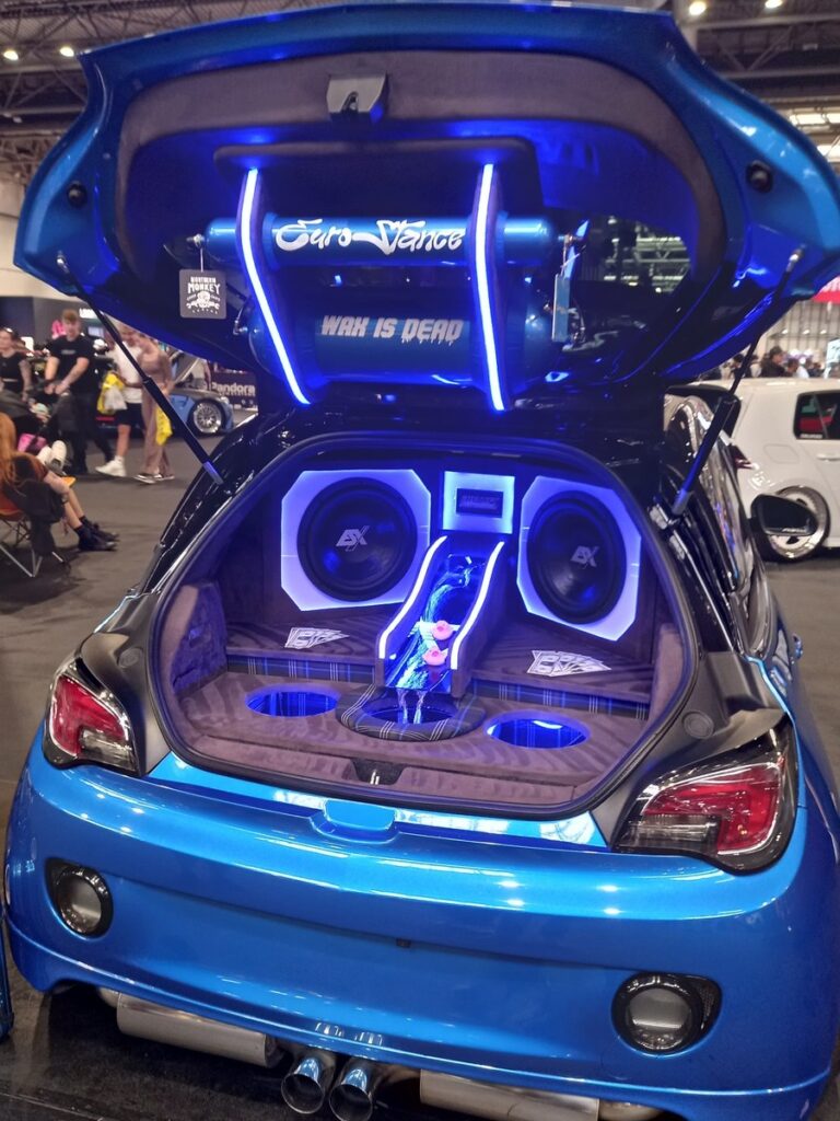 Blue Vauxhall Adam with a blue lit boot audio install, twin ESX subwoofers and an illuminated Euro Dance panel