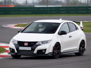 Honda Civic Type R FK2 at a British circuit apex with helmeted driver