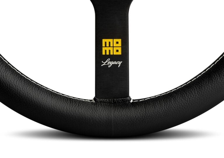 MOMO Legacy steering wheel detail of the engraved Legacy logo and enamelled Heritage emblem on the spoke