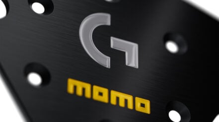 MOMO Sim GT 320 x Logitech G steering wheel, black microfibre rim and black anodised spokes, photographed at an angle