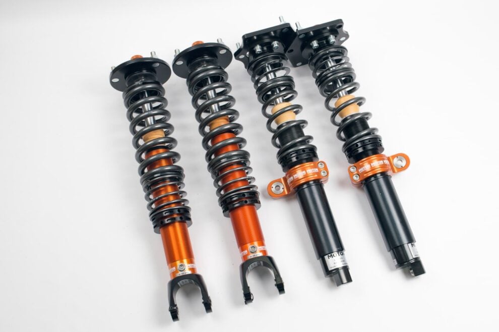 MOTON 1-way Clubracer coilover kit with orange rear bodies and black front struts, no reservoirs