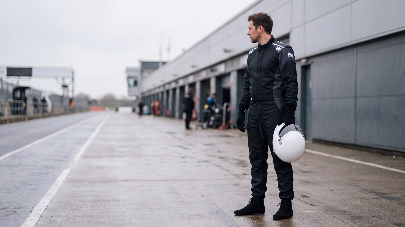 Driver in OMP One S Race Suit standing in the pit lane