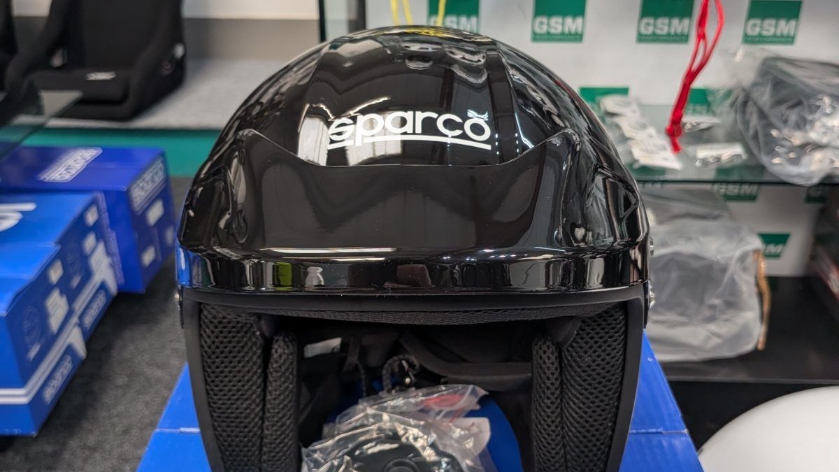 Close view of the black and grey Sparco J-Pro open face helmet on display in the GSM Performance showroom