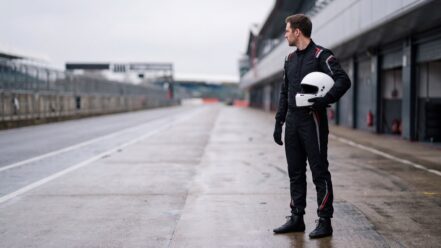 Driver in Sparco Prime Race Suit standing in the pit lane