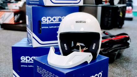 A white Sparco RJ open face helmet on its box in the GSM Performance showroom