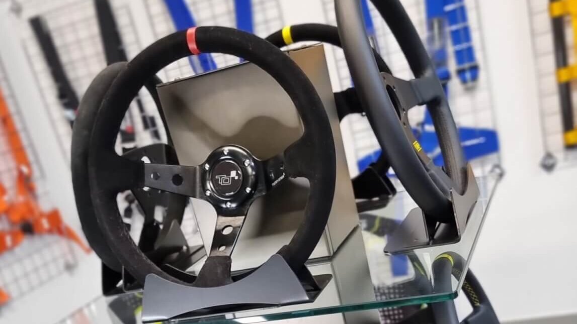Steering wheels on the glass display stand in the GSM Performance showroom