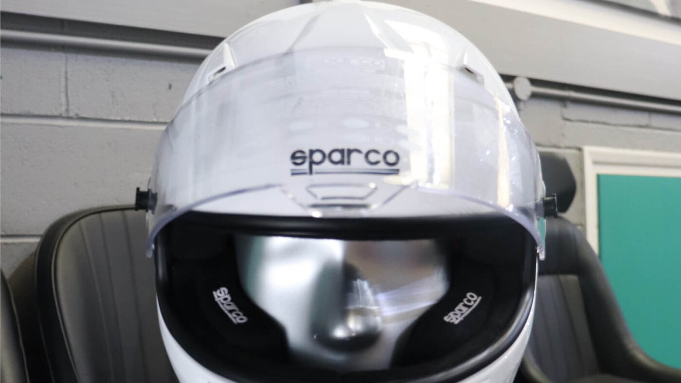 White Sparco Air Pro RF-5W full face helmet on a mannequin in the GSM Performance showroom