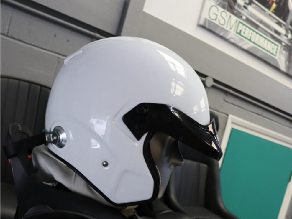 White Sparco Air Pro RJ-3 open face helmet from the side, with its peak and HANS post
