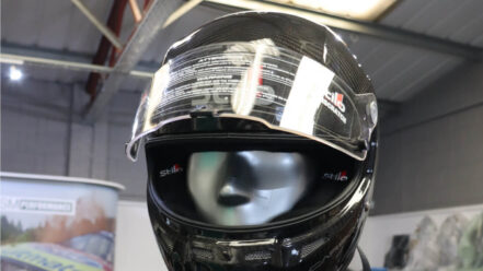 Carbon Stilo ST5 FN helmet with a clear full visor, on a mannequin in the GSM Performance showroom