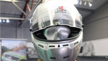 Silver Stilo ST5 FN composite helmet with a clear full visor, on a mannequin in the GSM Performance showroom