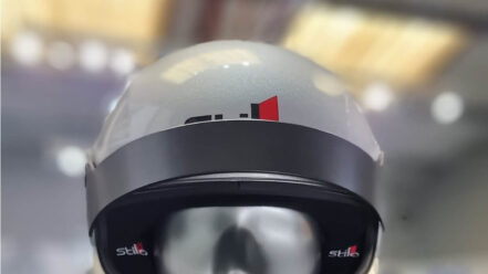 Silver Stilo ST5 GTN composite helmet with its short sunshade, on a mannequin in the GSM Performance showroom