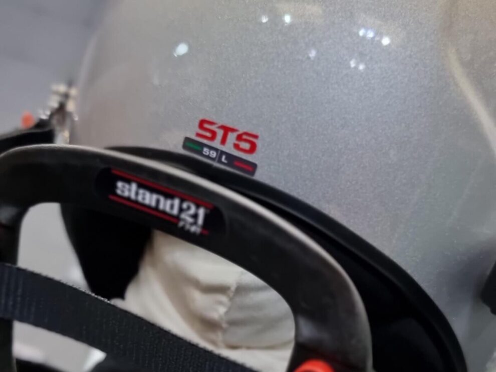 Stand21 Club Series 3 HANS device fitted behind a silver Stilo ST5 helmet, seen from behind