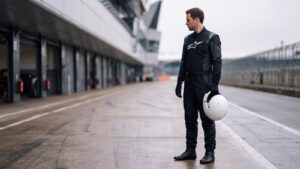 Driver in Alpinestars Hypertech V3 Race Suit standing in the pit lane