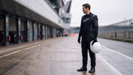 Driver in Alpinestars Hypertech V3 Race Suit standing in the pit lane