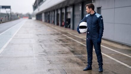 Driver in OMP Air Race Suit standing in the pit lane at a British circuit